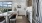 Model kitchen at our apartments for rent in Boulder, CO, featuring wood grain floor paneling and stainless steel appliances.